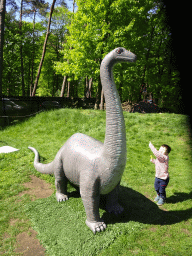 Max with a statue of a Diplodocus at the playground in the Oertijdwoud forest of the Oertijdmuseum