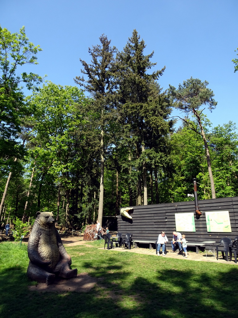 Statue of a Cave Bear at the playground and the Boshut restaurant in the Oertijdwoud forest of the Oertijdmuseum