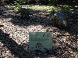 Statues of Minmis in the Oertijdwoud forest of the Oertijdmuseum, with explanation