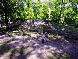 Max in front of a Skeleton of a Dinosaur in the Oertijdwoud forest of the Oertijdmuseum