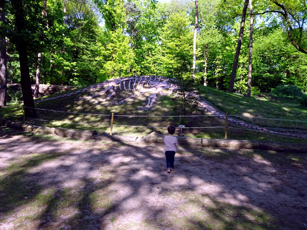 Max in front of a Skeleton of a Dinosaur in the Oertijdwoud forest of the Oertijdmuseum