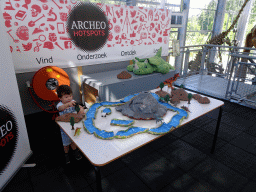 Max playing with dinosaur toys at the Middle Floor of the Dinohal building of the Oertijdmuseum