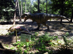 Statue of a Tyrannosaurus Rex in the Oertijdwoud forest of the Oertijdmuseum, with explanation