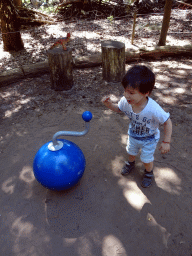 Max with a ball producing dinosaur sounds in the Oertijdwoud forest of the Oertijdmuseum