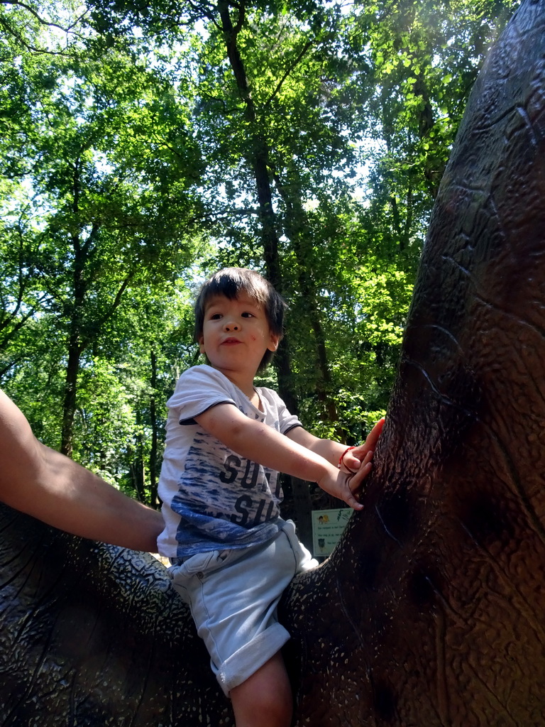 Max on a dinosaur statue in the Oertijdwoud forest of the Oertijdmuseum