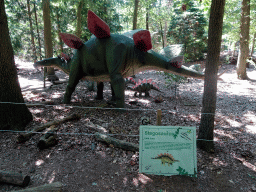 Statue of a Stegosaurus in the Oertijdwoud forest of the Oertijdmuseum, with explanation