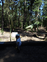 Max with statues of Europasauruses in the Oertijdwoud forest of the Oertijdmuseum