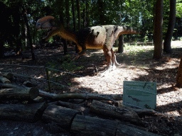 Statue of a Dilophosaurus in the Oertijdwoud forest of the Oertijdmuseum, with explanation