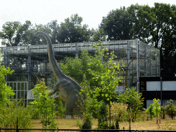 Statue of a Diplodocus in front of the Dinohal building of the Oertijdmuseum, viewed from the Oertijdwoud forest