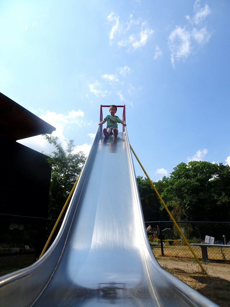 Max on the slide at the playground in the Garden of the Oertijdmuseum