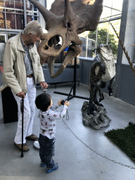 Max and his grandfather with the skull of a Triceratops and a Dinosaur statue at the Lower Floor of the Dinohal building of the Oertijdmuseum