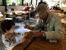 Max and his grandfather playing with Dinosaur toys in the restaurant at the Lower Floor of the Museum building of the Oertijdmuseum