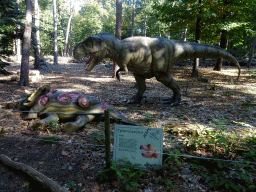 Statue of a Tyrannosaurus Rex in the Oertijdwoud forest of the Oertijdmuseum, with explanation