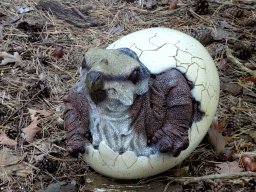 Statue of Triceratops coming out of an egg in the Oertijdwoud forest of the Oertijdmuseum