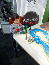 Max playing with dinosaur toys at the Middle Floor of the Dinohal building of the Oertijdmuseum