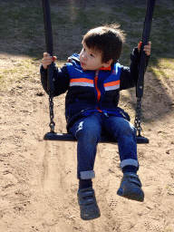 Max on a swing at the playground in the Garden of the Oertijdmuseum