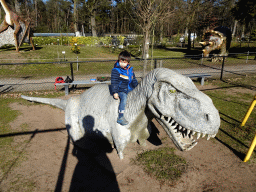 Max on a Dinosaur statue at the playground in the Garden of the Oertijdmuseum