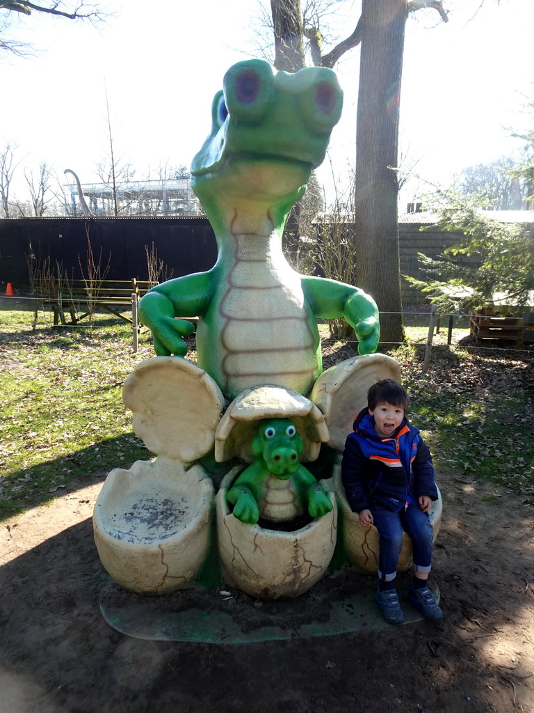Max on a statue of a Crocodile with eggs at the playground in the Oertijdwoud forest of the Oertijdmuseum