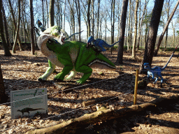Statue of a Tenontosaurus being attacked by Deinonychuses in the Oertijdwoud forest of the Oertijdmuseum, with explanation