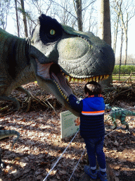 Max with a statue of a Tyrannosaurus Rex in the Oertijdwoud forest of the Oertijdmuseum