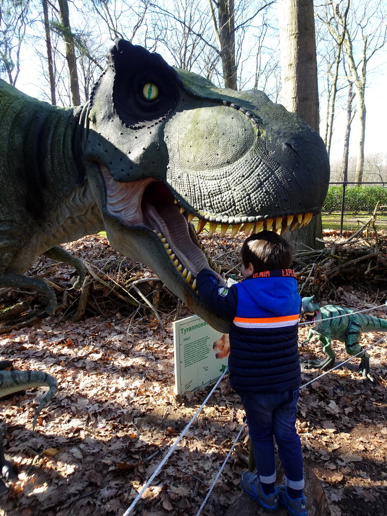 Max with a statue of a Tyrannosaurus Rex in the Oertijdwoud forest of the Oertijdmuseum