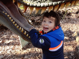 Max with a statue of a Tyrannosaurus Rex in the Oertijdwoud forest of the Oertijdmuseum