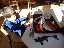 Max having lunch with a Mosasaurus toy in the restaurant at the Lower Floor of the Museum building of the Oertijdmuseum