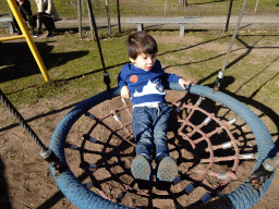 Max on a swing at the playground in the Garden of the Oertijdmuseum