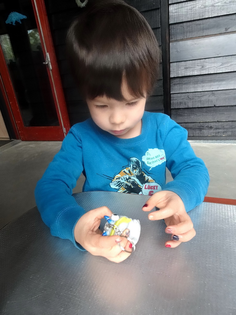 Max playing with a dinosaur toy in the hallway from the Dinohal building to the Museum building of the Oertijdmuseum