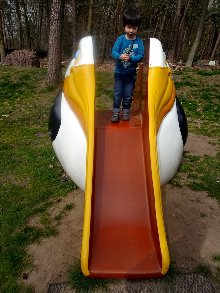 Max on a Pelican slide at the playground in the Oertijdwoud forest of the Oertijdmuseum