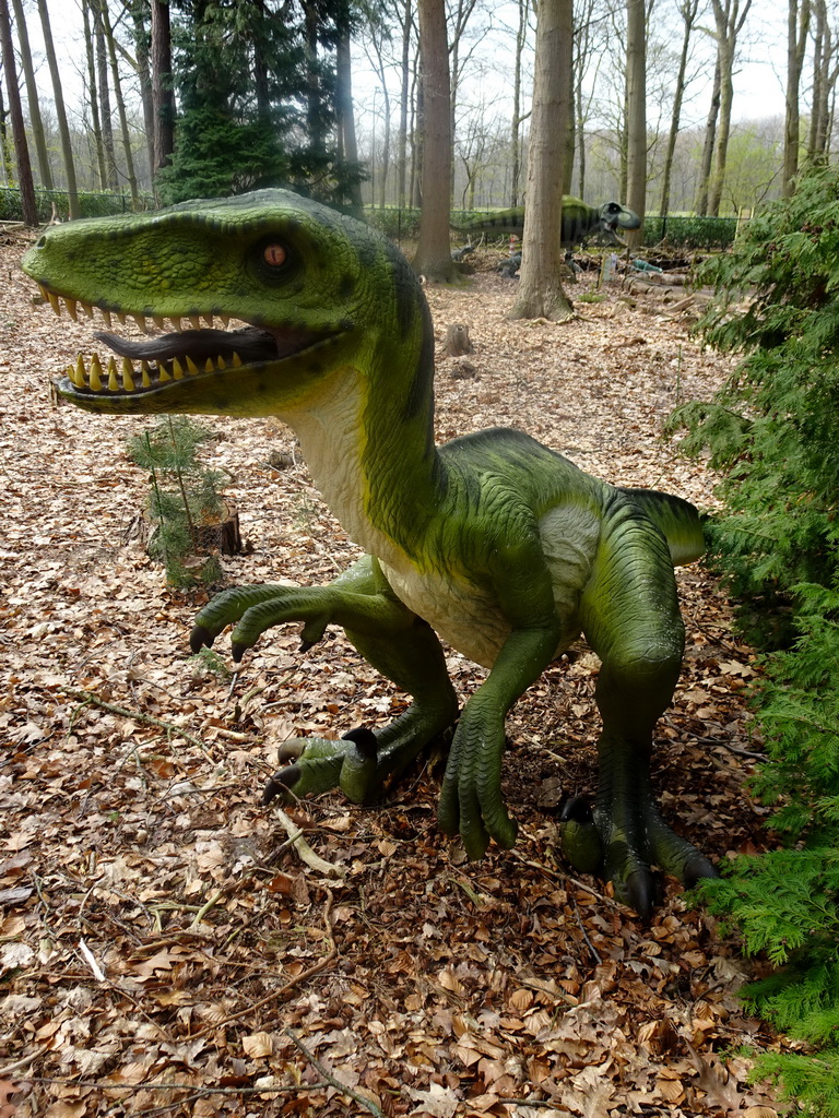 Statue of a Dromaeosaurus in the Oertijdwoud forest of the Oertijdmuseum