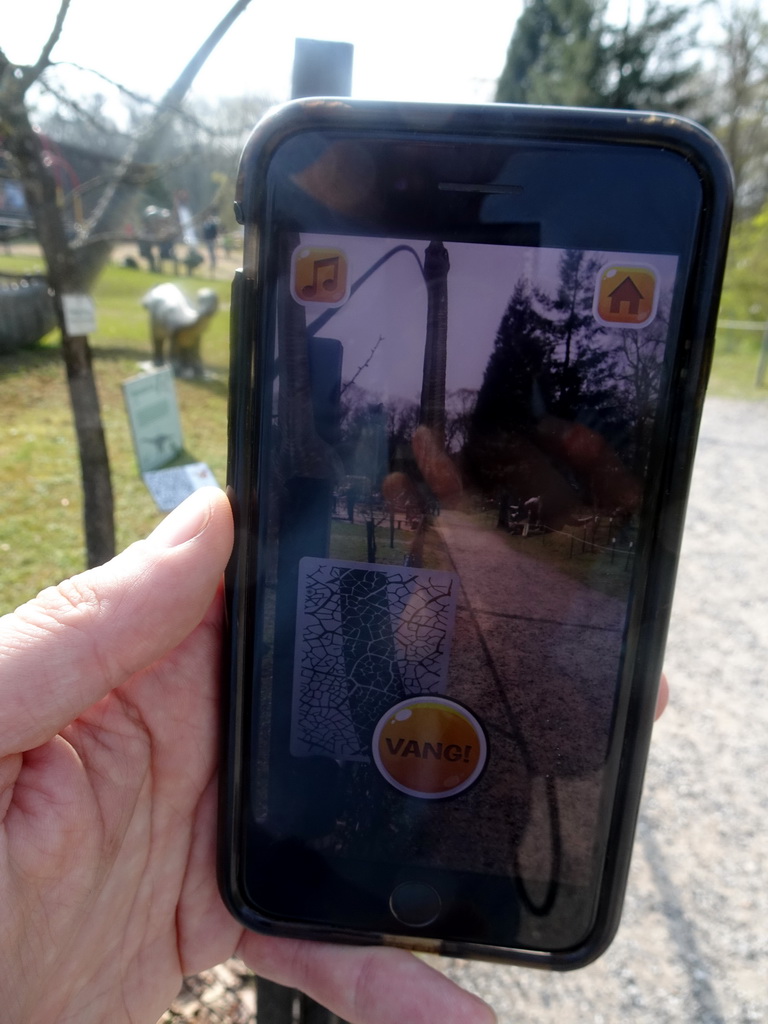 Mobile phone showing the Dino Hunter Boxtel app in the Garden of the Oertijdmuseum