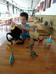 Max playing with dinosaur toys at the restaurant at the Lower Floor of the Museum building of the Oertijdmuseum