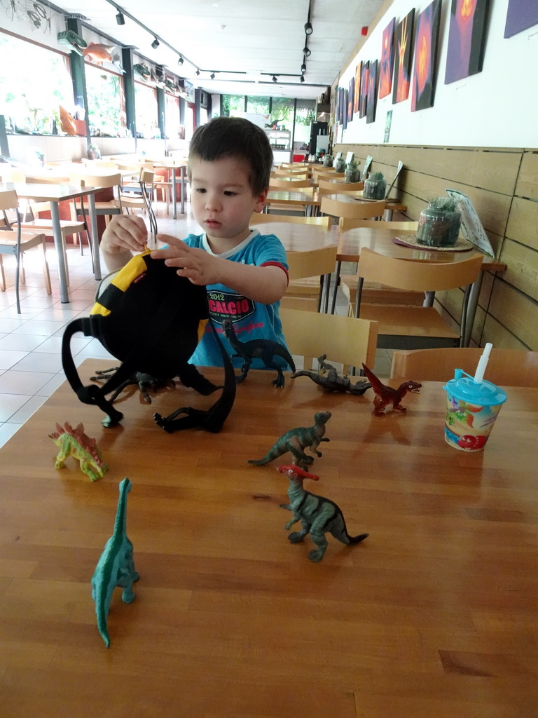 Max playing with dinosaur toys at the restaurant at the Lower Floor of the Museum building of the Oertijdmuseum