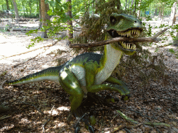 Statue of a Dromaeosaurus in the Oertijdwoud forest of the Oertijdmuseum