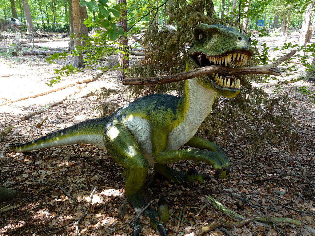 Statue of a Dromaeosaurus in the Oertijdwoud forest of the Oertijdmuseum