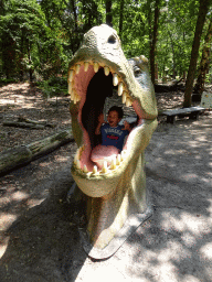 Max in a statue of the head of a Dinosaur in the Oertijdwoud forest of the Oertijdmuseum