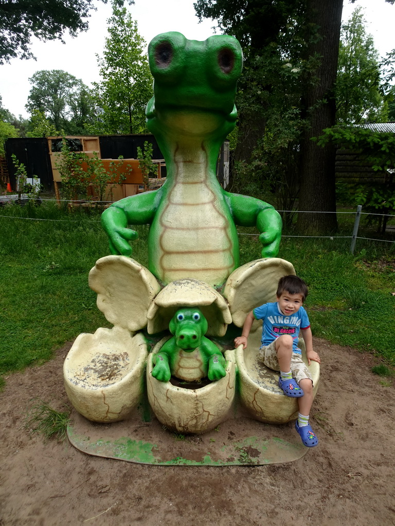 Max on a statue of a Crocodile with eggs at the playground in the Oertijdwoud forest of the Oertijdmuseum