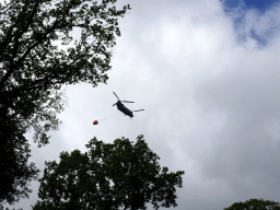 Army helicopter flying over the Oertijdwoud forest of the Oertijdmuseum