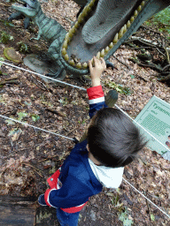 Max with a statue of a Tyrannosaurus Rex in the Oertijdwoud forest of the Oertijdmuseum