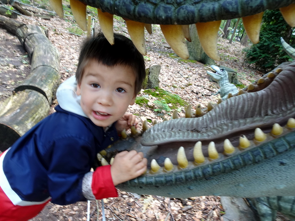Max with a statue of a Tyrannosaurus Rex in the Oertijdwoud forest of the Oertijdmuseum