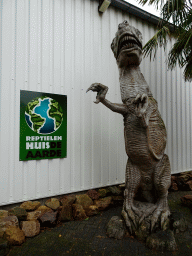 Entrance sign and statue of a Tyrannosaurus Rex at the entrance to the Reptielenhuis De Aarde zoo at the Aardenhoek street