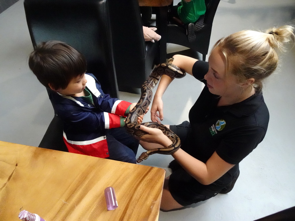 Max and a zookeeper with a Ball Python at the lower floor of the Reptielenhuis De Aarde zoo