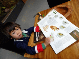 Max with an animal book at the lower floor of the Reptielenhuis De Aarde zoo