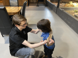 Zookeeper and Max with a Ball Python at the lower floor of the Reptielenhuis De Aarde zoo