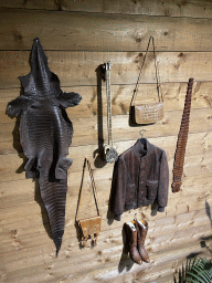 Items made from reptile skin on the wall of the Reptielenhuis De Aarde zoo, viewed from the left staircase