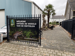 Entrance sign and statue of a Tyrannosaurus Rex at the entrance to the Reptielenhuis De Aarde zoo at the Aardenhoek street