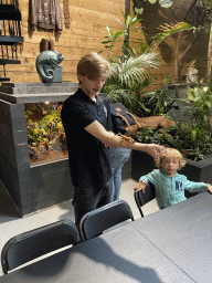 Zookeeper with an Australian Walking Stick at the lower floor of the Reptielenhuis De Aarde zoo