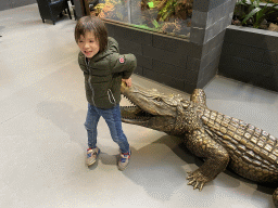 Max with a Crocodile statue at the lower floor of the Reptielenhuis De Aarde zoo