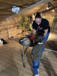 Max getting a snake button at the upper floor of the Reptielenhuis De Aarde zoo, during the Halloween 2020 event